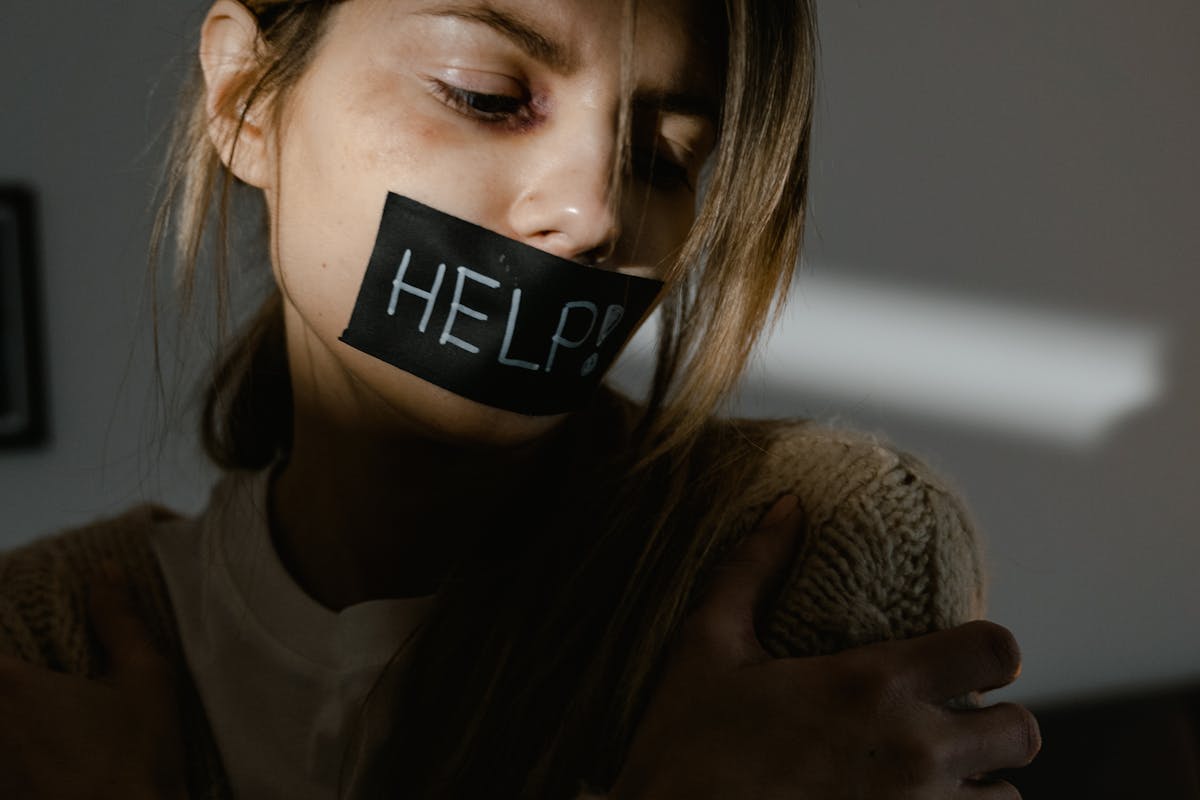 woman with an adhesive tape on her mouth